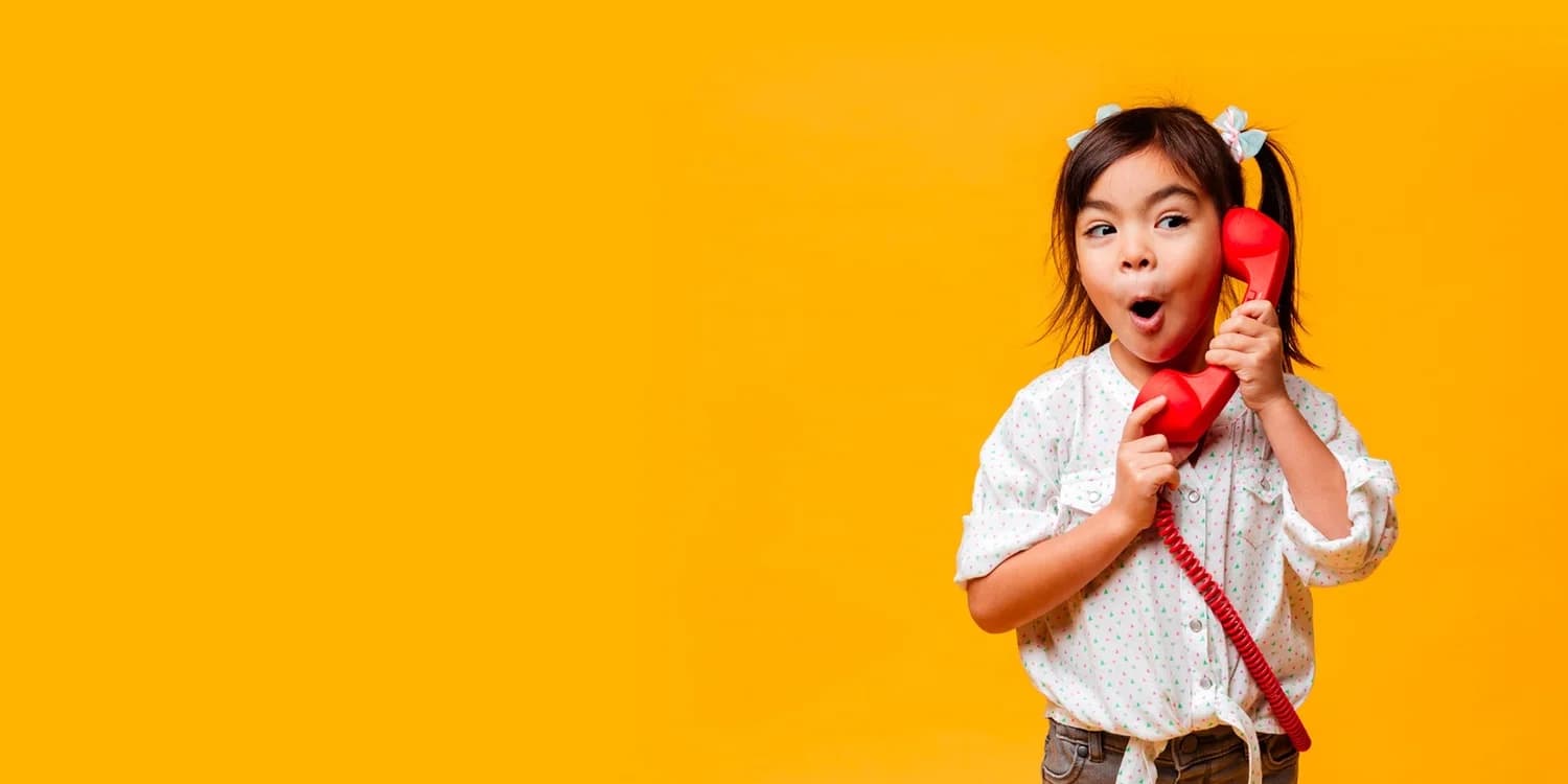 A smiling child in a yellow dress at Emery's Playhouse